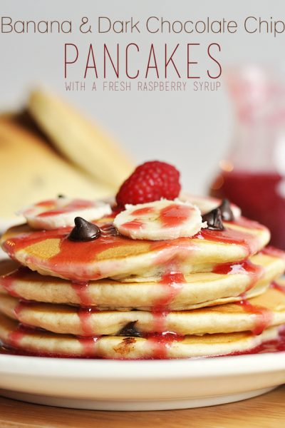Enjoy this delicious and beautiful Banana and Dark Chocolate Chip Pancakes Recipe for a special occasion, or just because! Topped off with a Fresh Raspberry Syrup