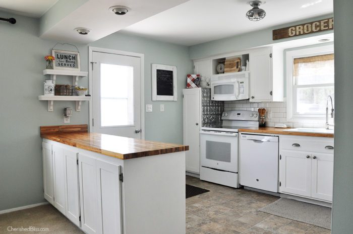 Before Picture - This industrial farmhouse kitchen is both functional and inviting. Stainless steel appliances bring a professional industrial look while adding softer elements provides the comfort of a farmhouse. 