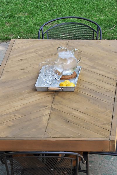 Build this DIY Outdoor Table featuring a Herringbone Top and X Brace Legs! Would also make a great Rustic Dining Room Table!