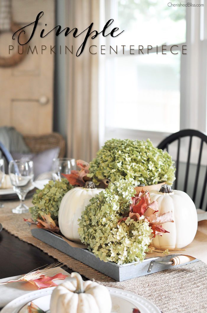 Transform your dining room table from boring to beautiful with this Simple Fall Centerpiece. Together these white pumpkins and dried hydrangeas will leave your Fall table looking gorgeous!