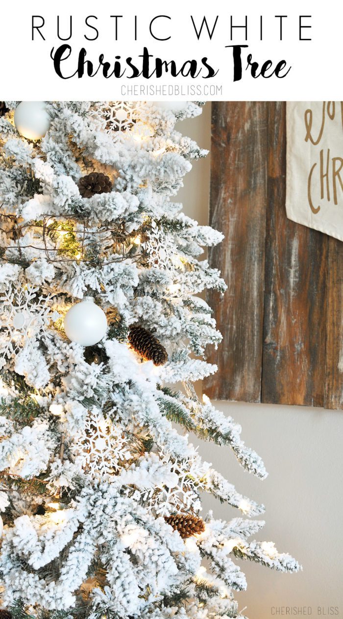 A simple White Flocked Christmas tree with white ornaments and a few rustic touches