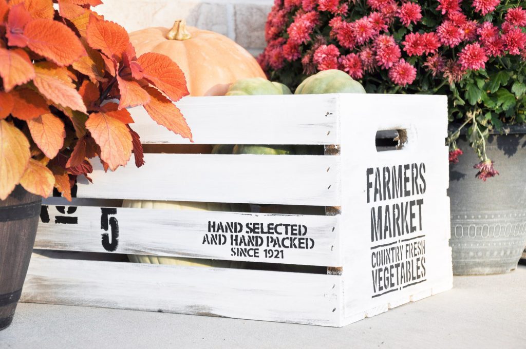 Create this beautiful DIY Fall Farmhouse Crate with a ready made crate, paint and a stencil. The perfect way to provide a farmhouse feel to your Fall Decor.