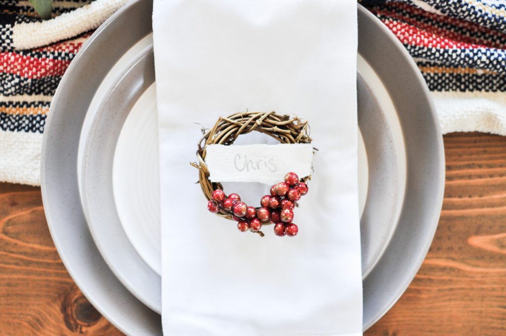 This quick and easy craft is the perfect addition to your holiday table. Make your guests feel welcome with their very own Mini Wreath Christmas Place Card! 