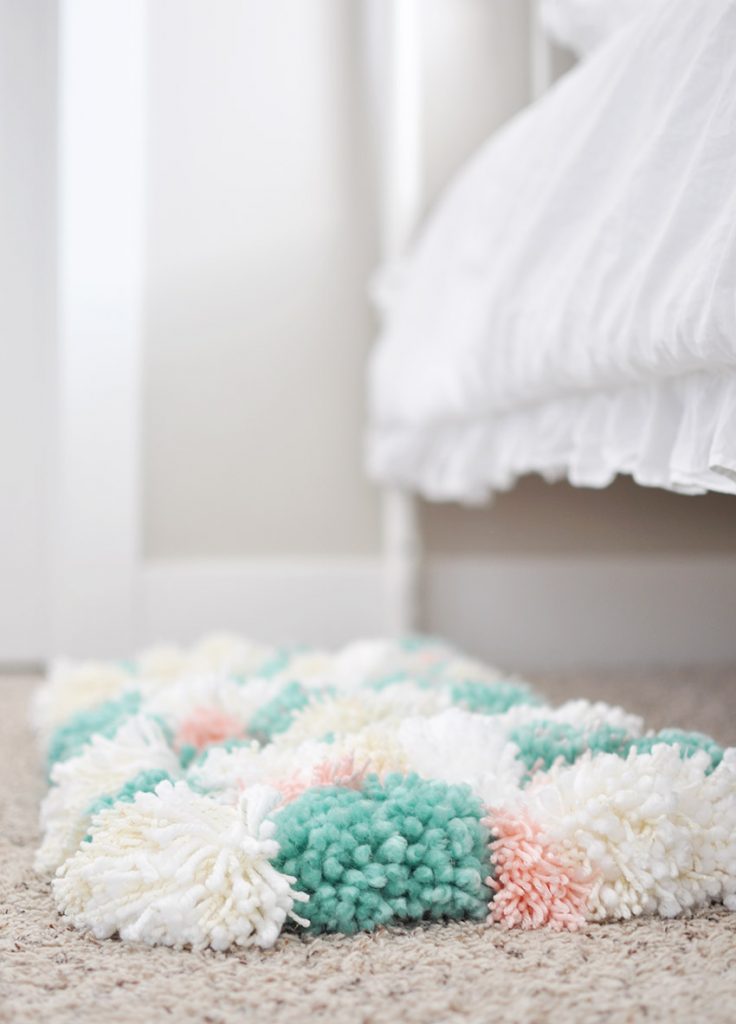 Learn how to create this amazing DIY Pom Pom Rug using Bucilla's new RyaTie™ Kits. This modern take on working with yarn is the perfect addition to any room