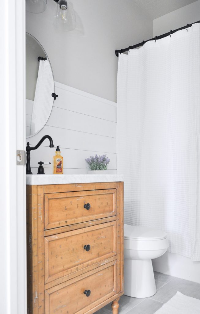 This light and airy bathroom is the perfect way to transform a small stuffy space into something you will love. Visit the post to get all the details on this Modern Farmhouse Bathroom.