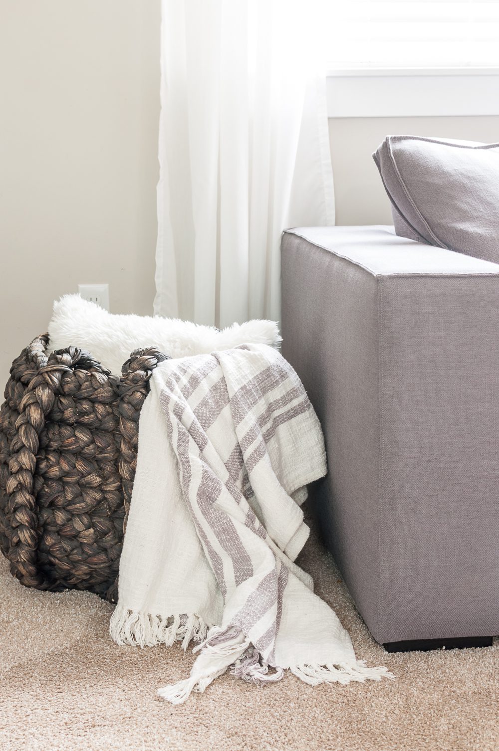 bring in warm textures to a minimalist living room to provide a cozy element that feels like home.