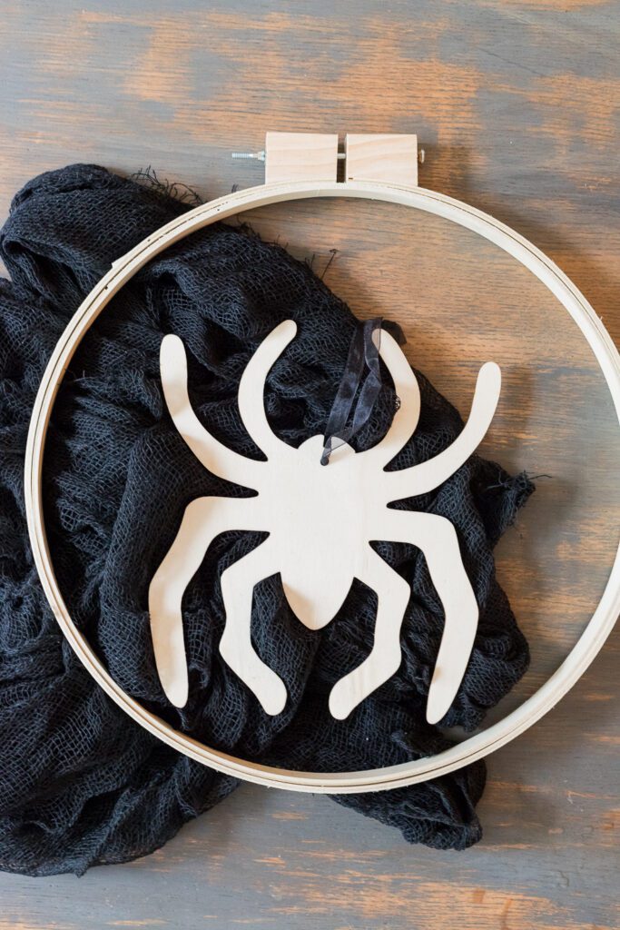 Learn how to make this easy Embroidery Hoop Halloween Wreath. It's the perfect addition to your door for all the trick or treaters to come! 