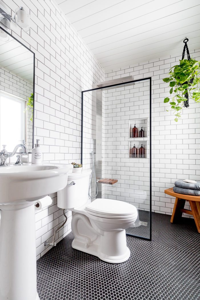Use a shower screen in a bathroom to make the room feel bigger like this industrial bathroom.