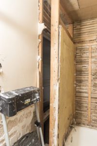 Extend closet into bathroom by reframing the walls