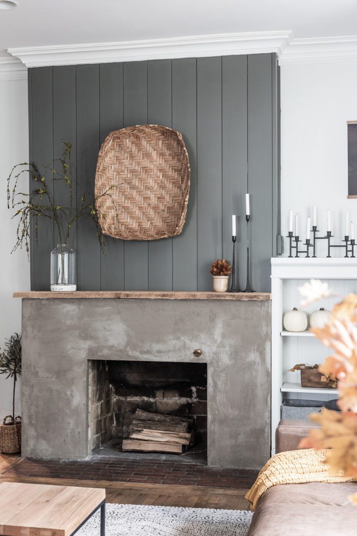 Green Shiplap above concrete fireplace with Modern Traditional Fall Decor.