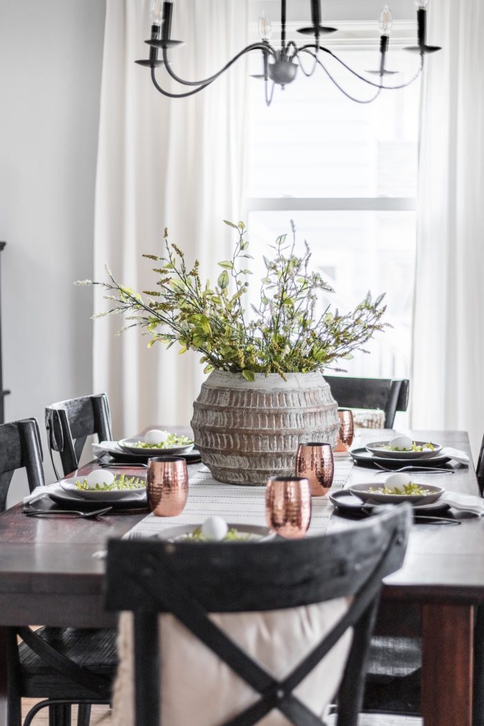 Modern Classic Easter Tablescape with dark wood table, black chairs and a simple centerpiece. 
