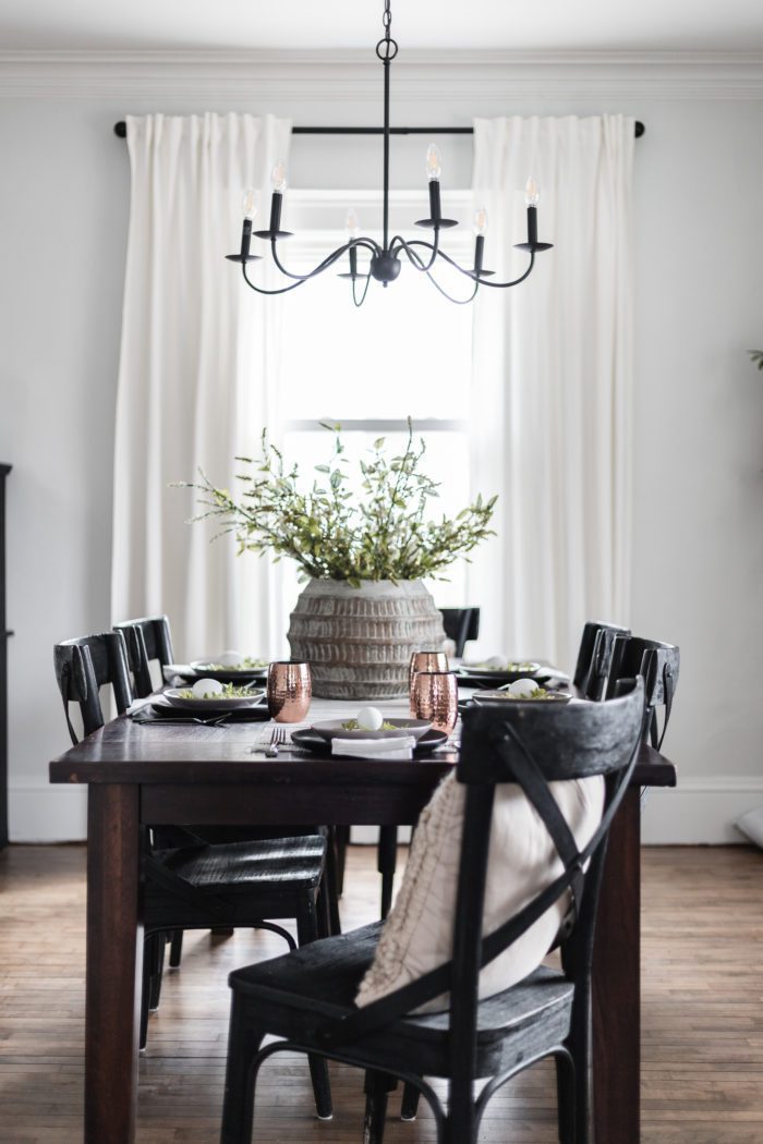Modern Classic Easter Tablescape with dark wood table, black chairs and a simple centerpiece. 