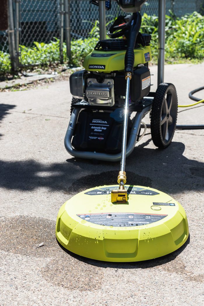 Use a surface cleaner with a pressure washer to clean your driveway and sidewalks. 