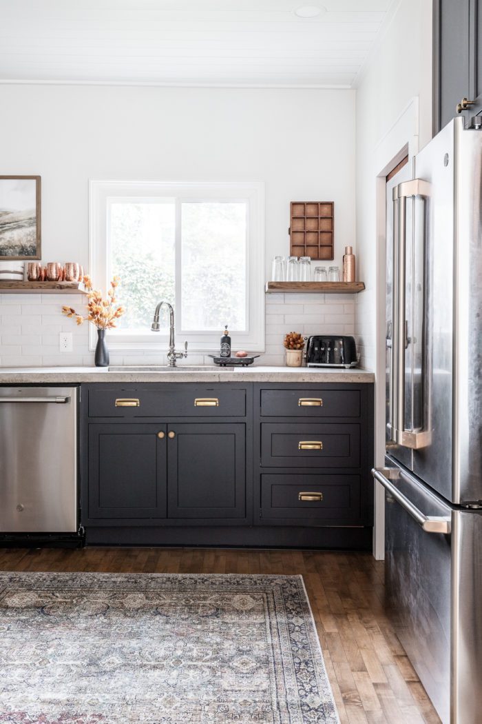 Fall kitchen decor with black cabinets and open shelving. 