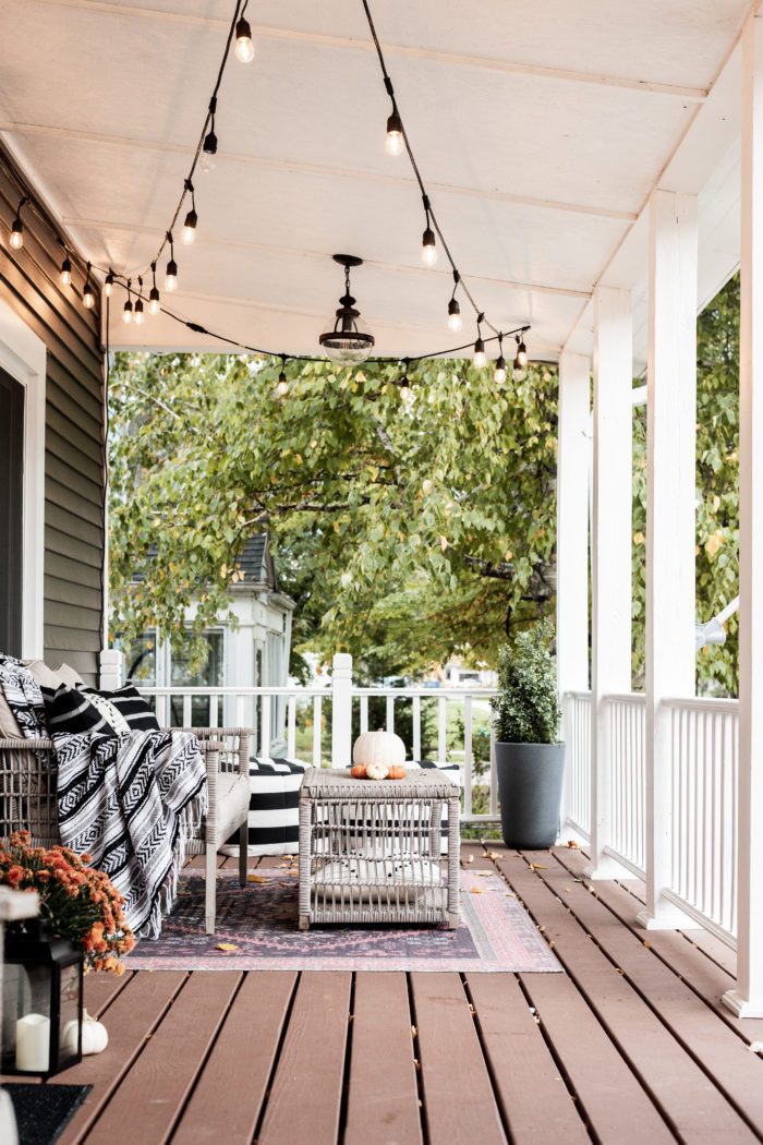 Front Porch Decorated for Fall with throw blankets and pillows. 