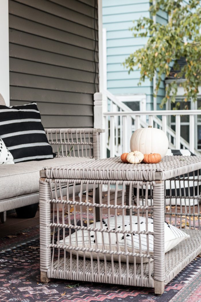 coffee table on front porch decorated with pumpkins