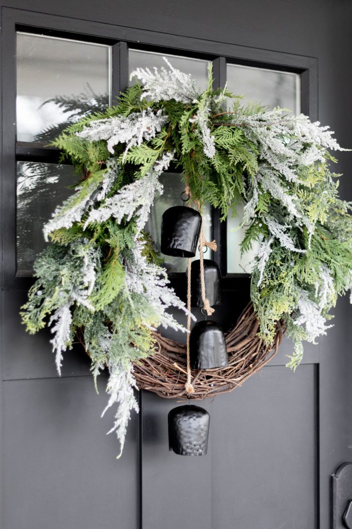 Stunning Modern Organic Christmas Wreath hanging on black front door. 