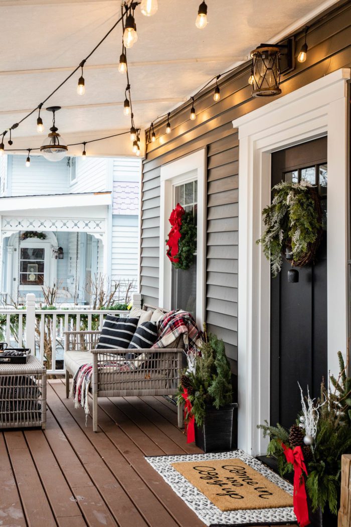 Cozy Christmas Decor on front porch of historical home. 