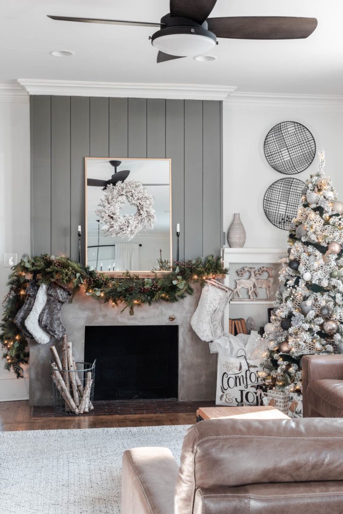 Concrete fireplace with shiplap decorated for Christmas with a Rustic Luxe Christmas Mantel. 