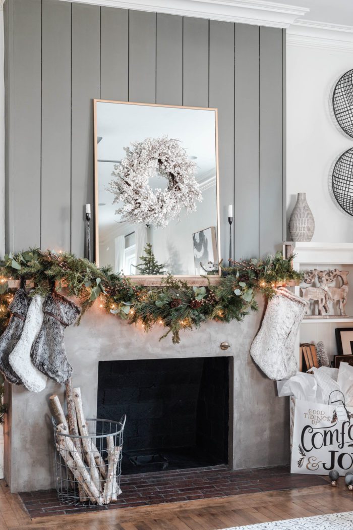 concrete fireplace with shiplap decorated for Christmas. 