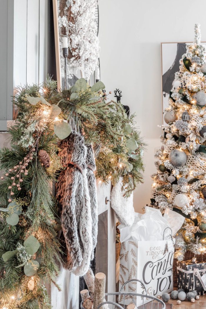 Faux garland mixed with stems and fresh clippings to create decor for a Rustic Luxe Christmas Mantel. 