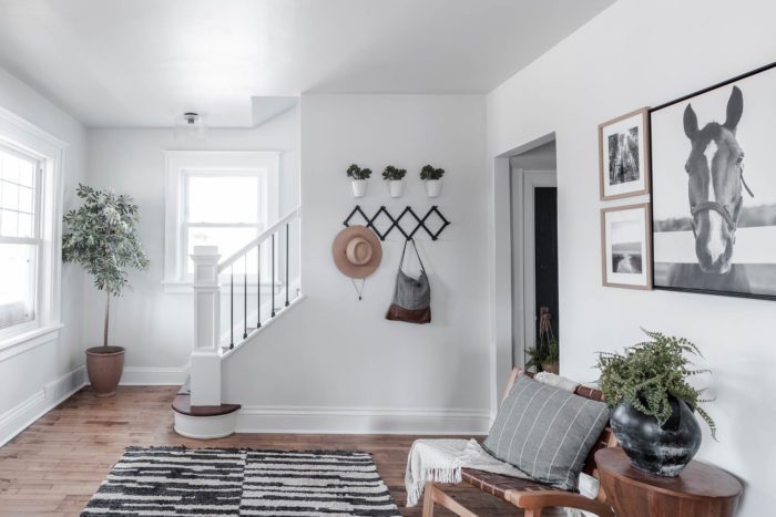 Step into this large entryway that greets you with a gallery wall, two chairs, and plenty of space to hang your coats! 