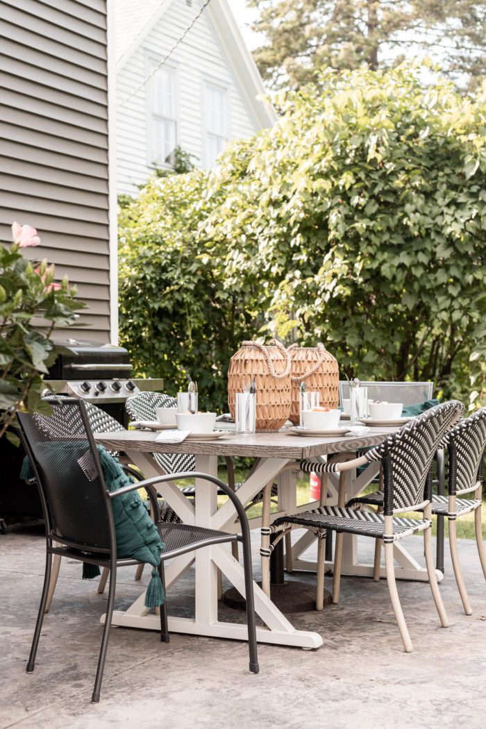 An Outdoor Summer Tablescape on a stamped concrete patio is the perfect way to enjoy a family meal this summer.