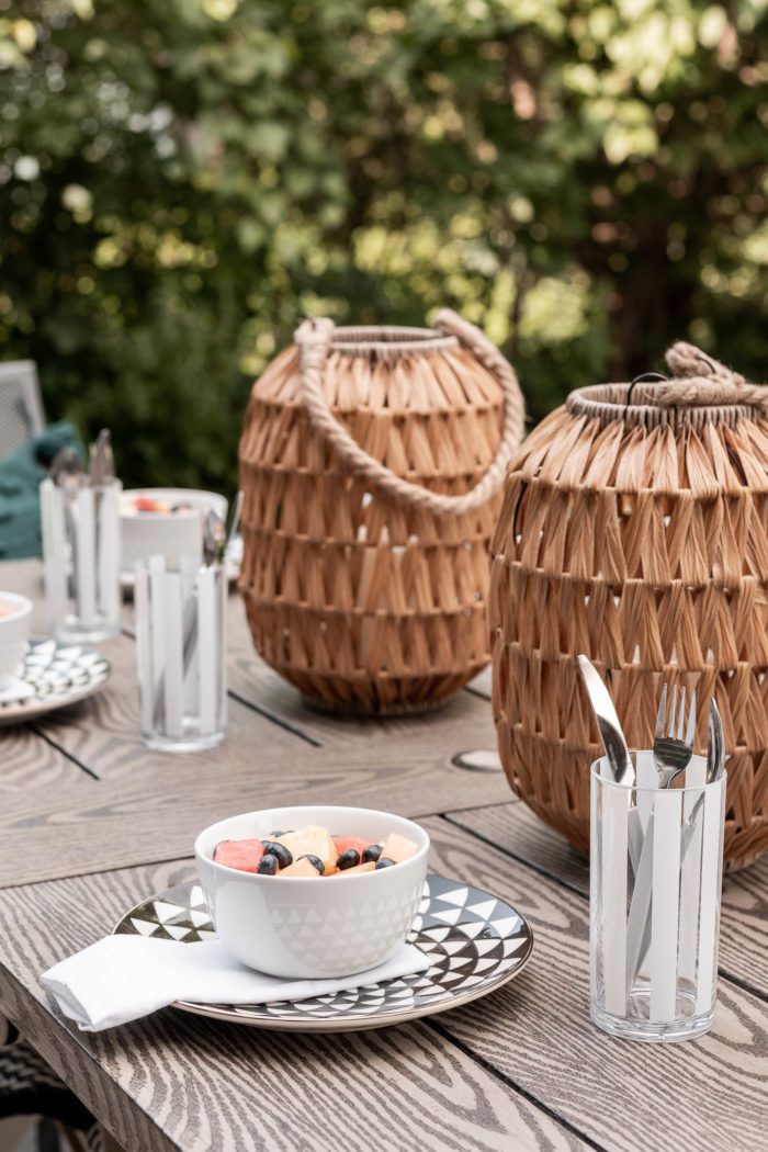 Outdoor wicker lanterns used as a centerpiece for a Summer Table Setting. 