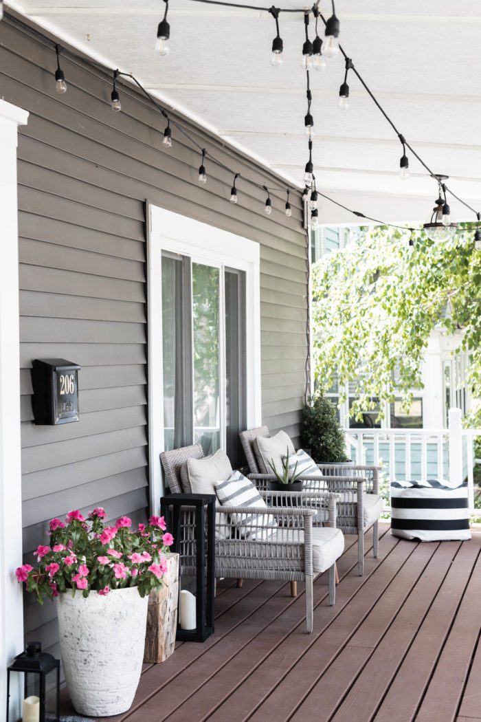 Summer Porch Refresh with fresh flowers, matching chairs, and soft poufs for the perfect evening on this front porch in a Modern Craftsman House. 