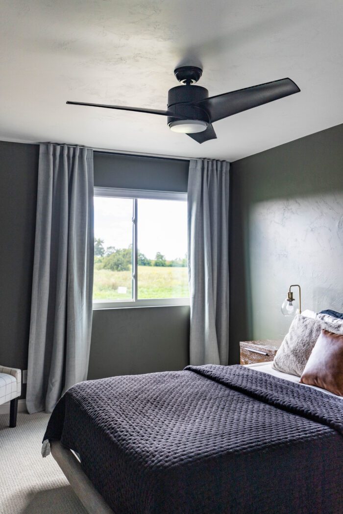 Black Ceiling fan in teenage boy's bedroom. 