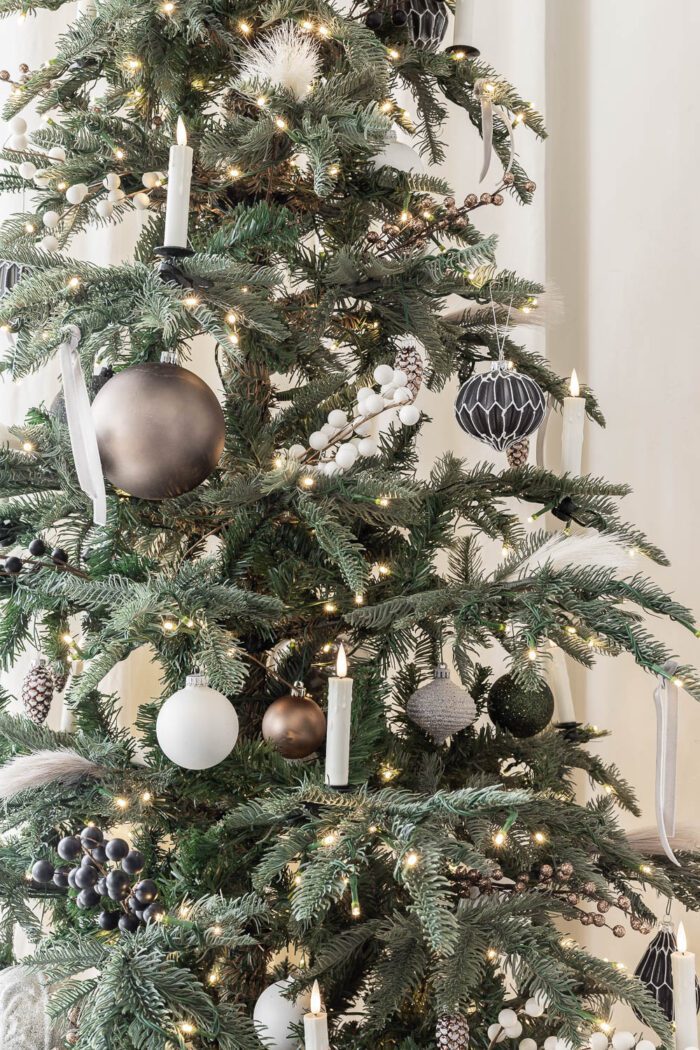 Neutral Ornaments on a noble fir tree in the dining room. 