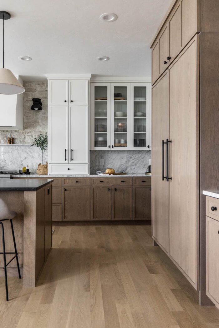 Modern European-inspired kitchen with reeded glass cabinet doors. 