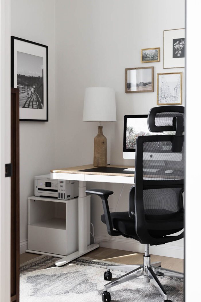 Standing desk and ergonomic chair in a home office. 